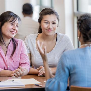 Mother and daughter receiving financial advice at a bank